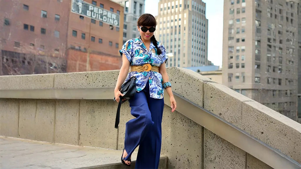 What do you think about the girl wearing a belt over her Hawaiian shirt and carrying a handbag?